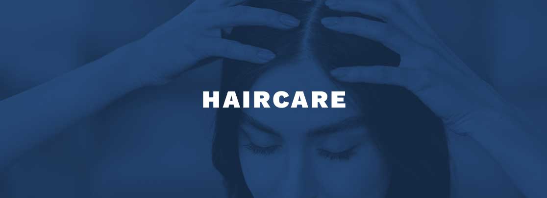 Woman examining her scalp with title "HAIRCARE"