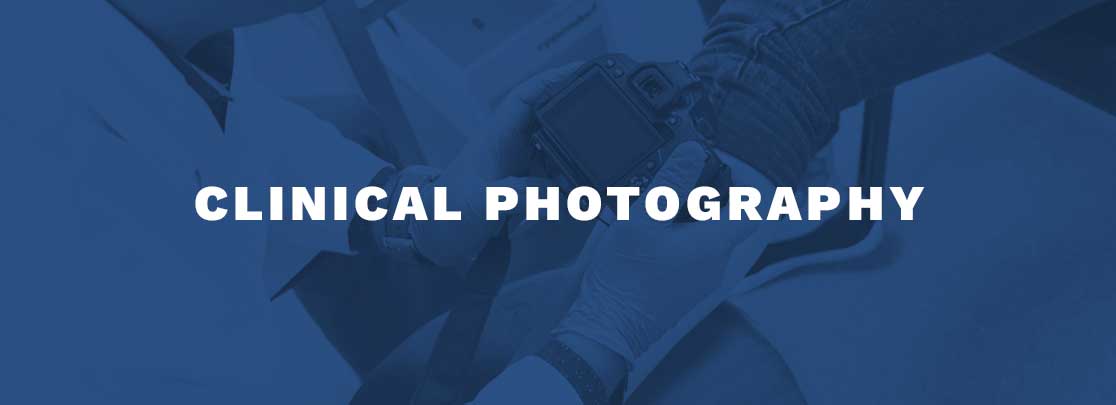 Photograph of a Dr. Vanu taking a photo of skin with "CLINICAL PHOTOGRAPHY" title