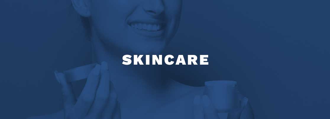 woman smiling with lotion in hands with heading "SKINCARE"